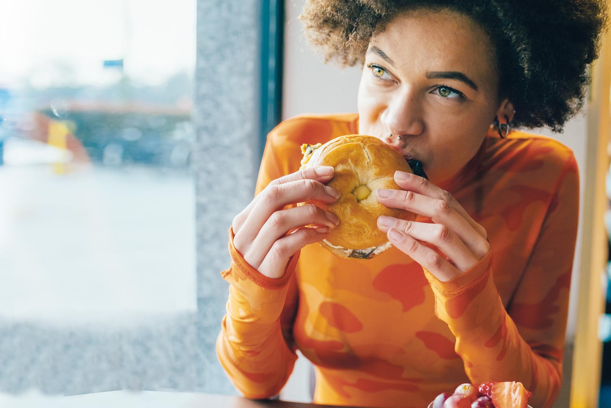 Woman eating a bagel