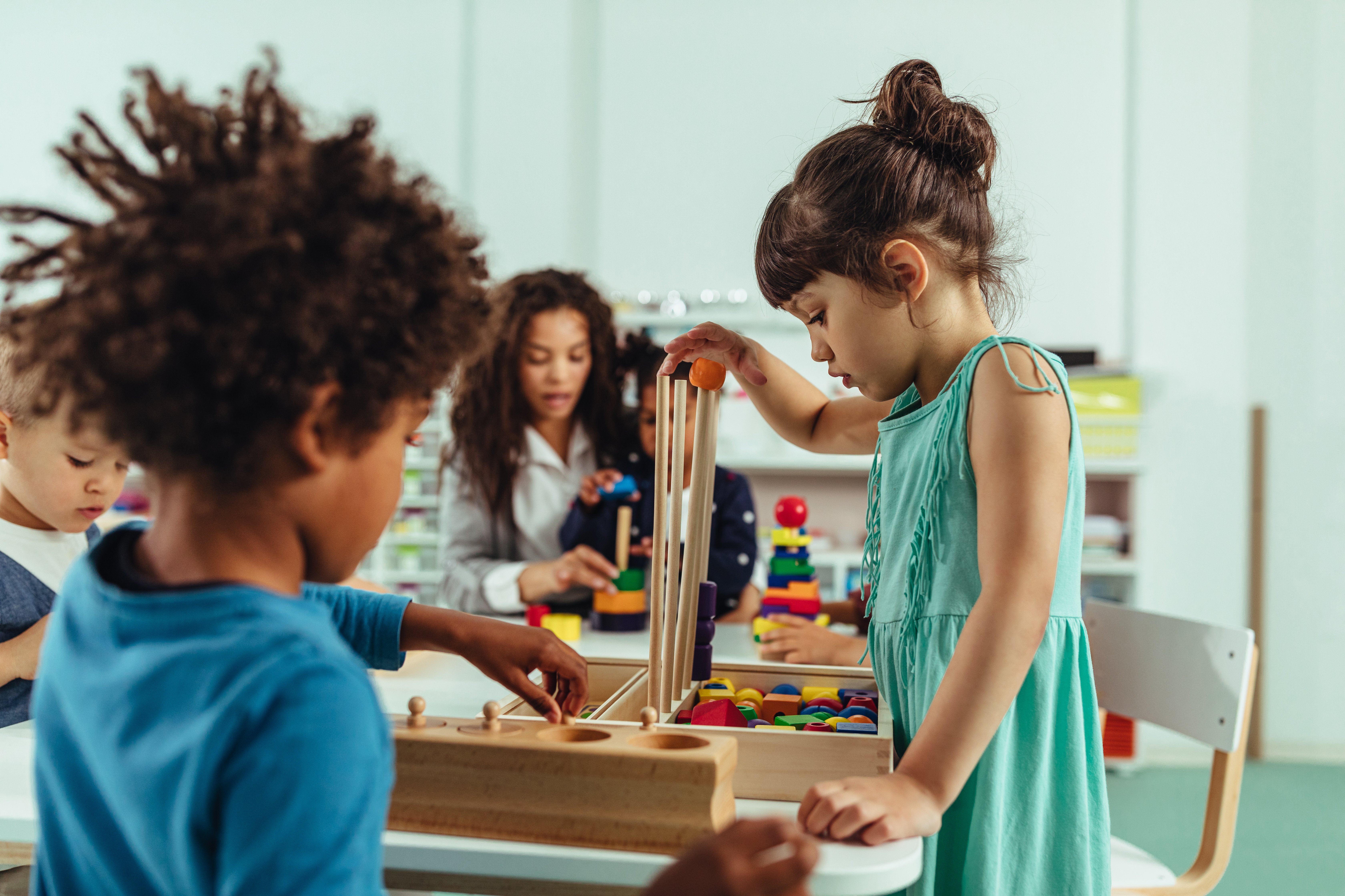 Girl playing with wooden toys