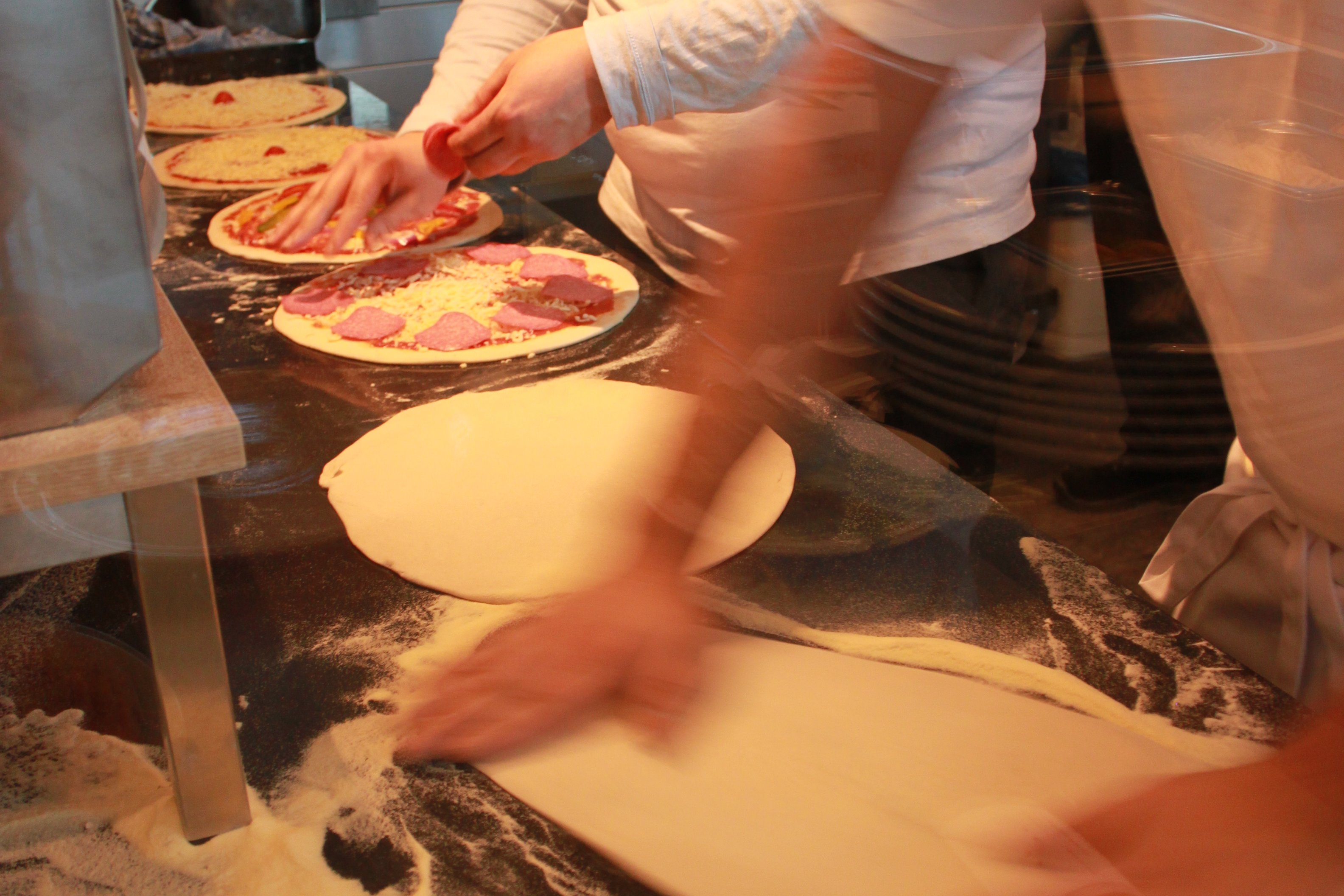Pizza chefs preparing pizzas at Schlüters