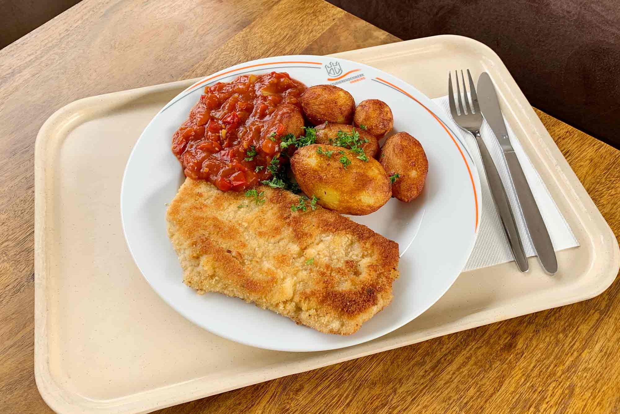 Schnitzel with potatoes and sauce on a plate