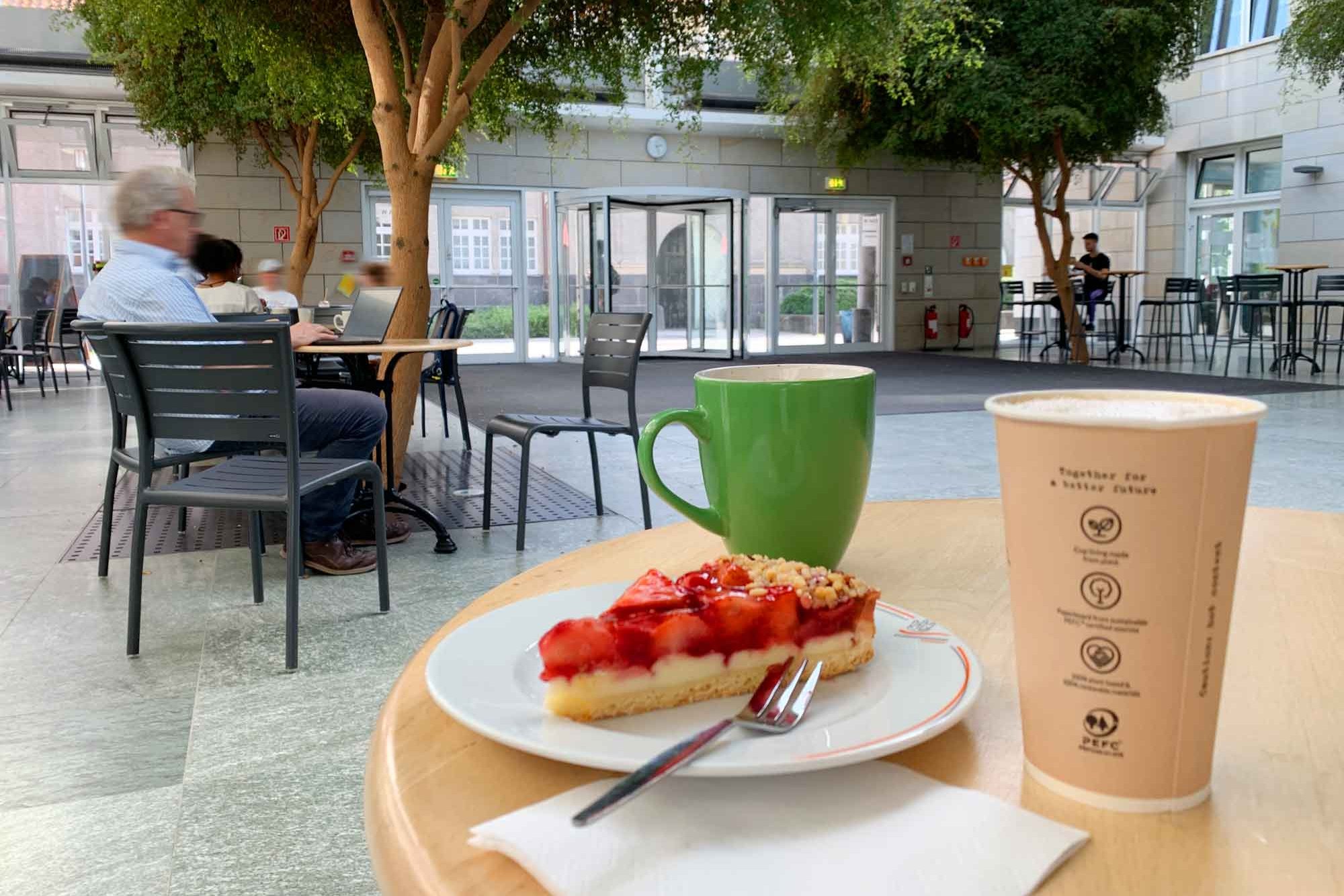 Coffee and a slice of strawberry cake on a plate