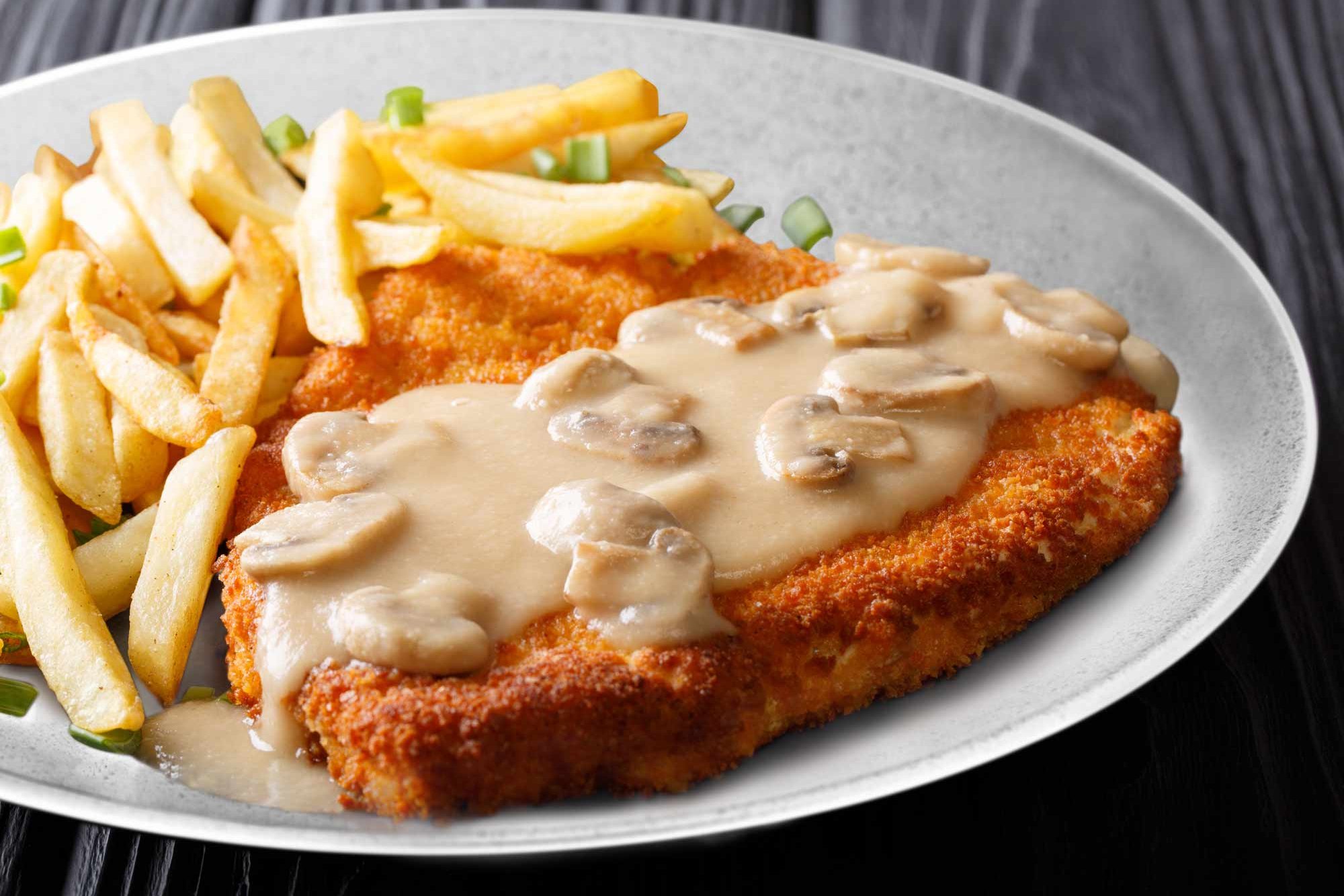 Schnitzel with mushroom cream sauce and French fries