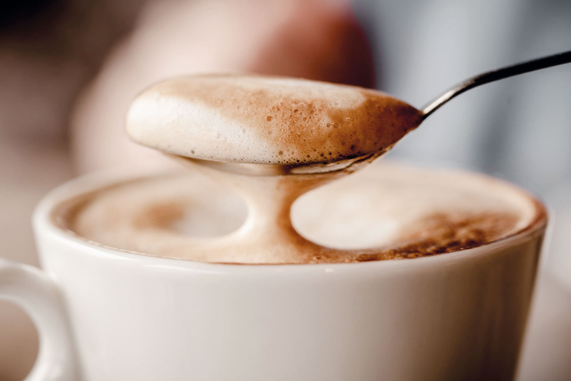 Cup of cappuccino with spoon at Café Student Affairs