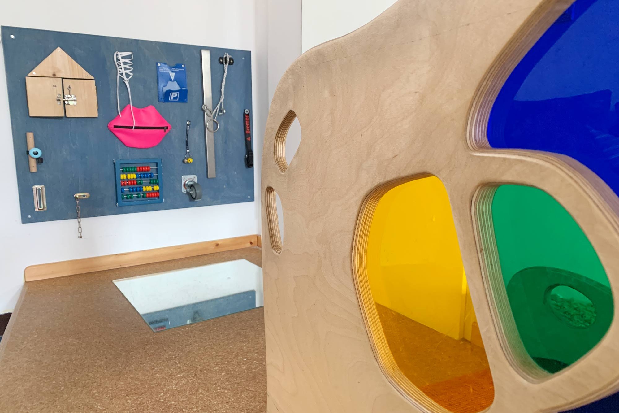 A playroom with an activity board at the UKE daycare center