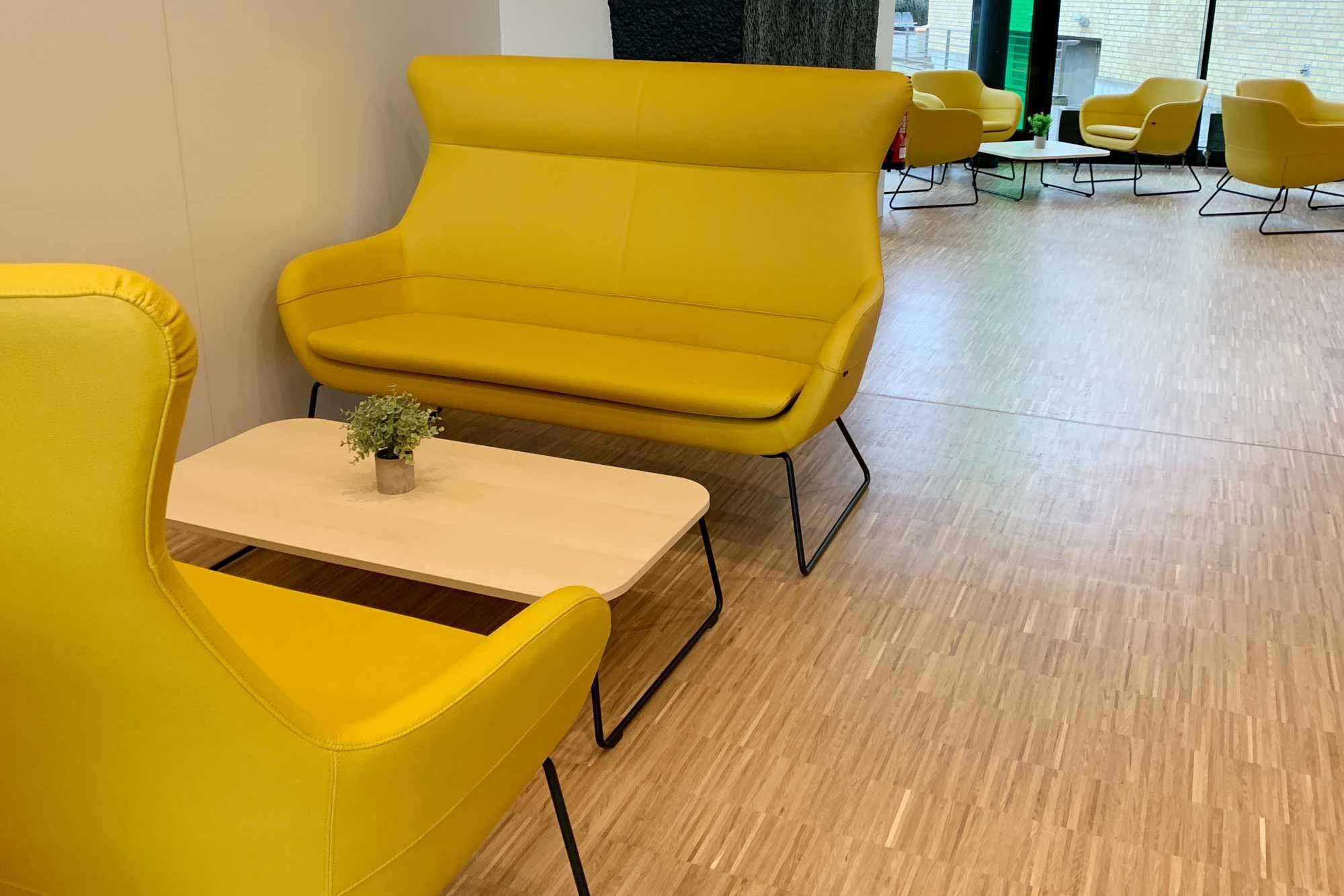 Seating area with yellow sofas in the Cafeteria Philturm