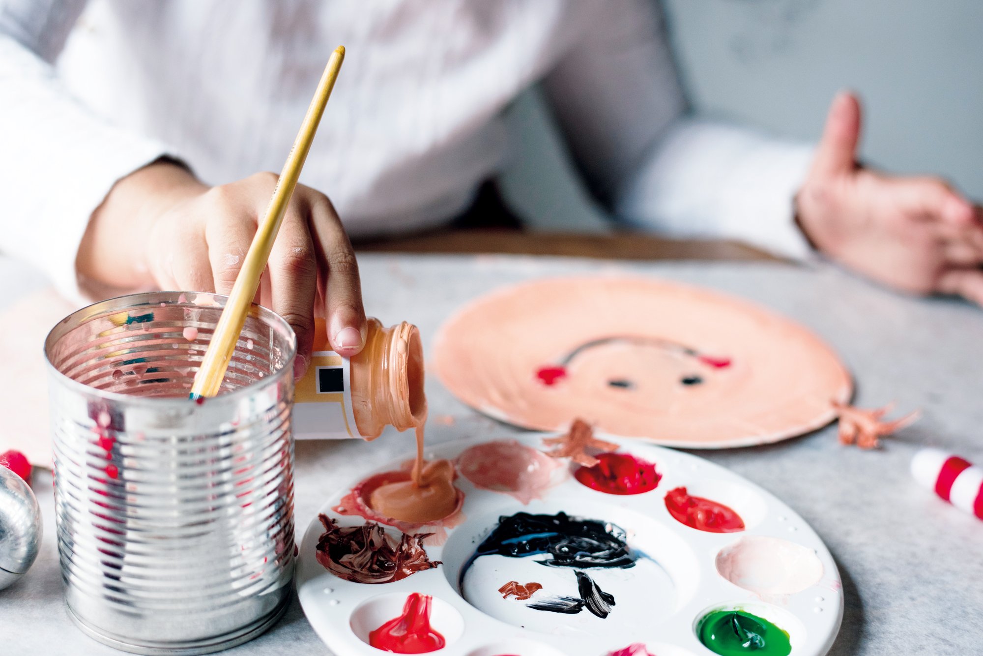 Small child with paint palette and brush