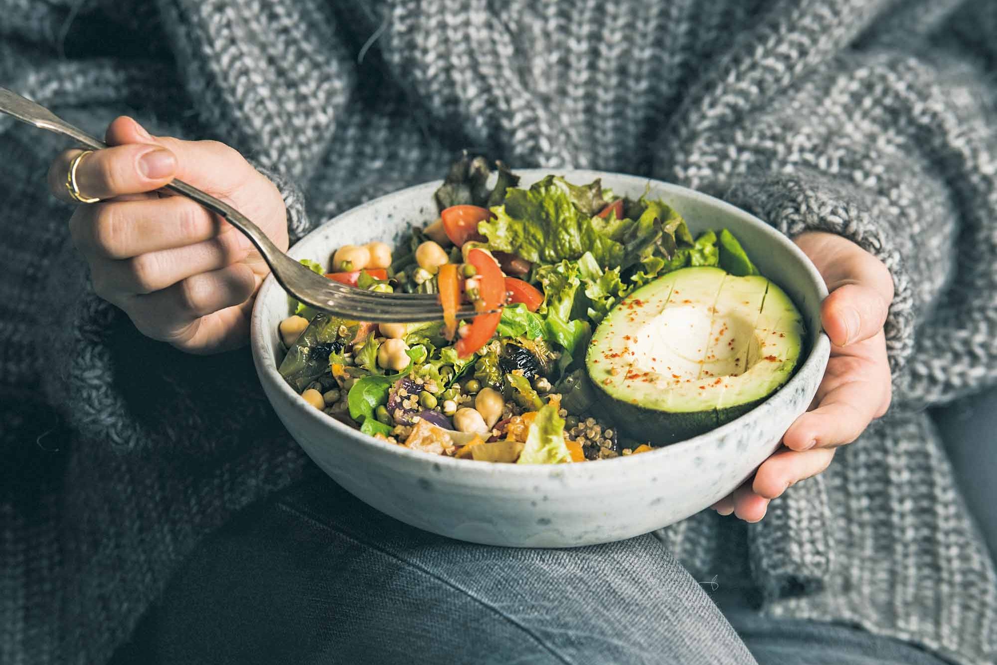 Woman eating a bowl in the Cafeteria Finkenau