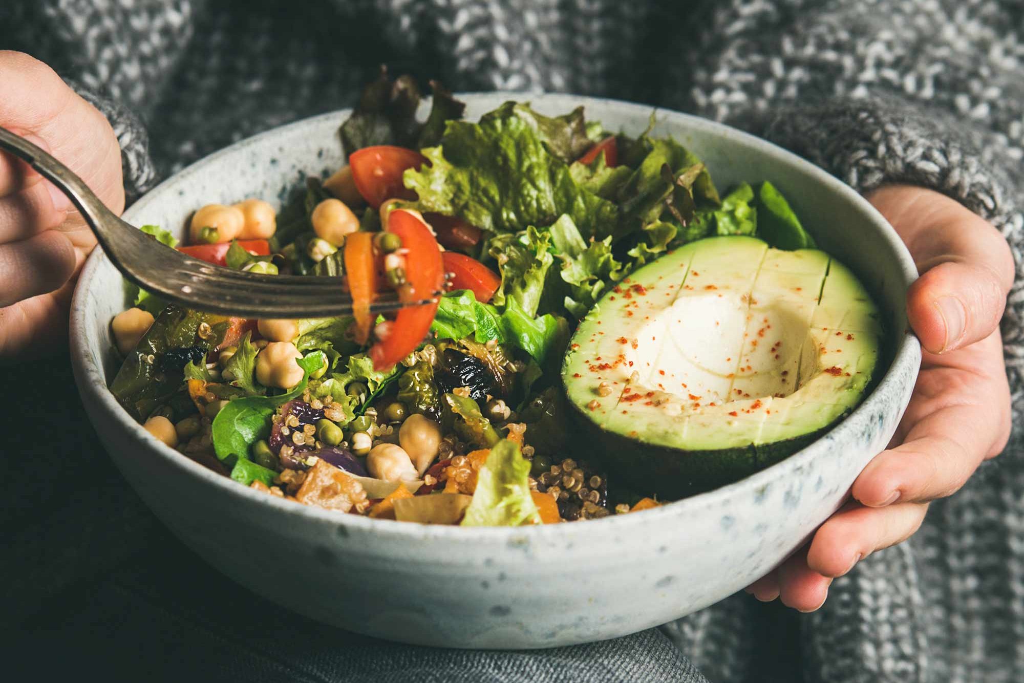 Hands holding a vegetable bowl
