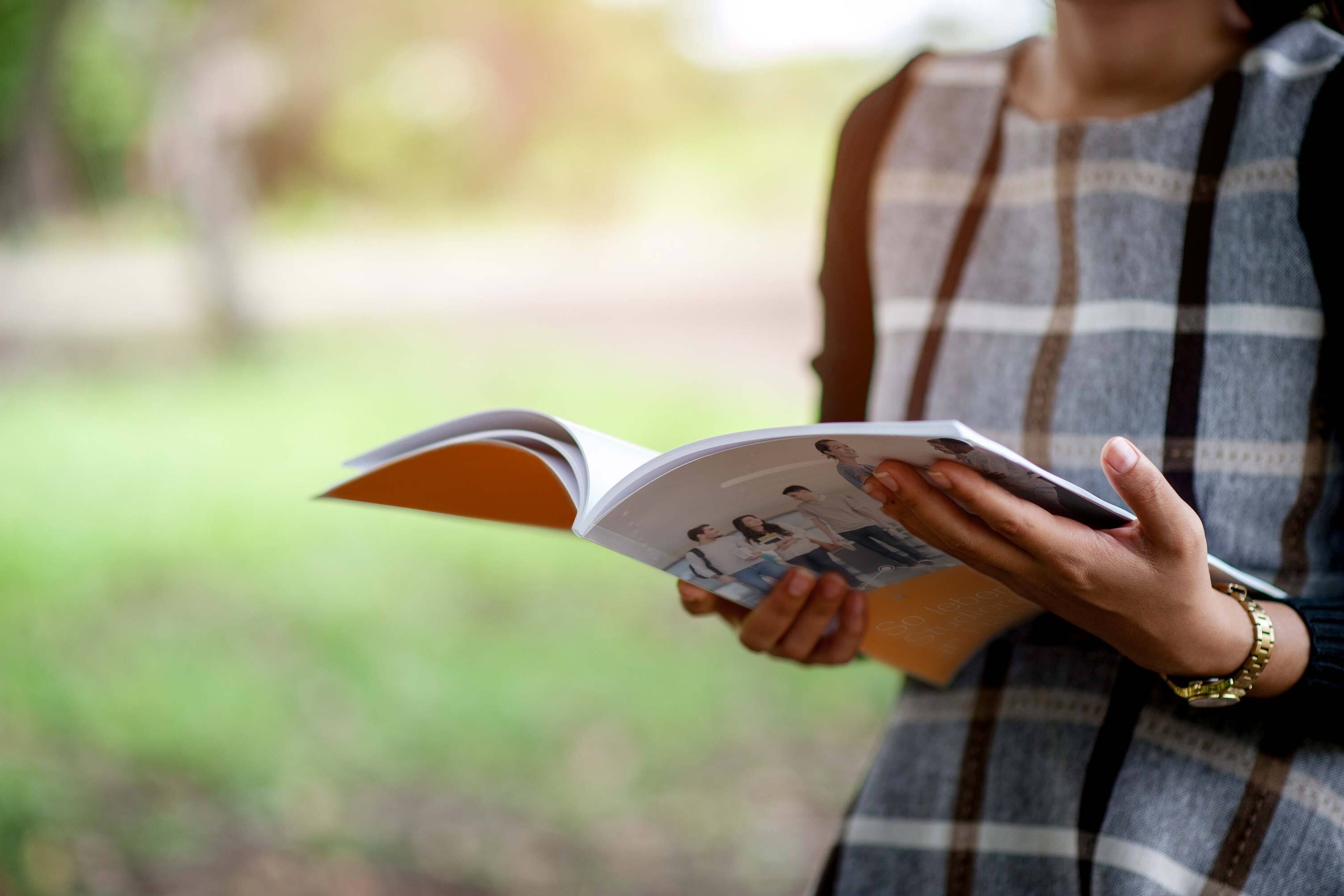 Woman holding the Social Survey in her hand