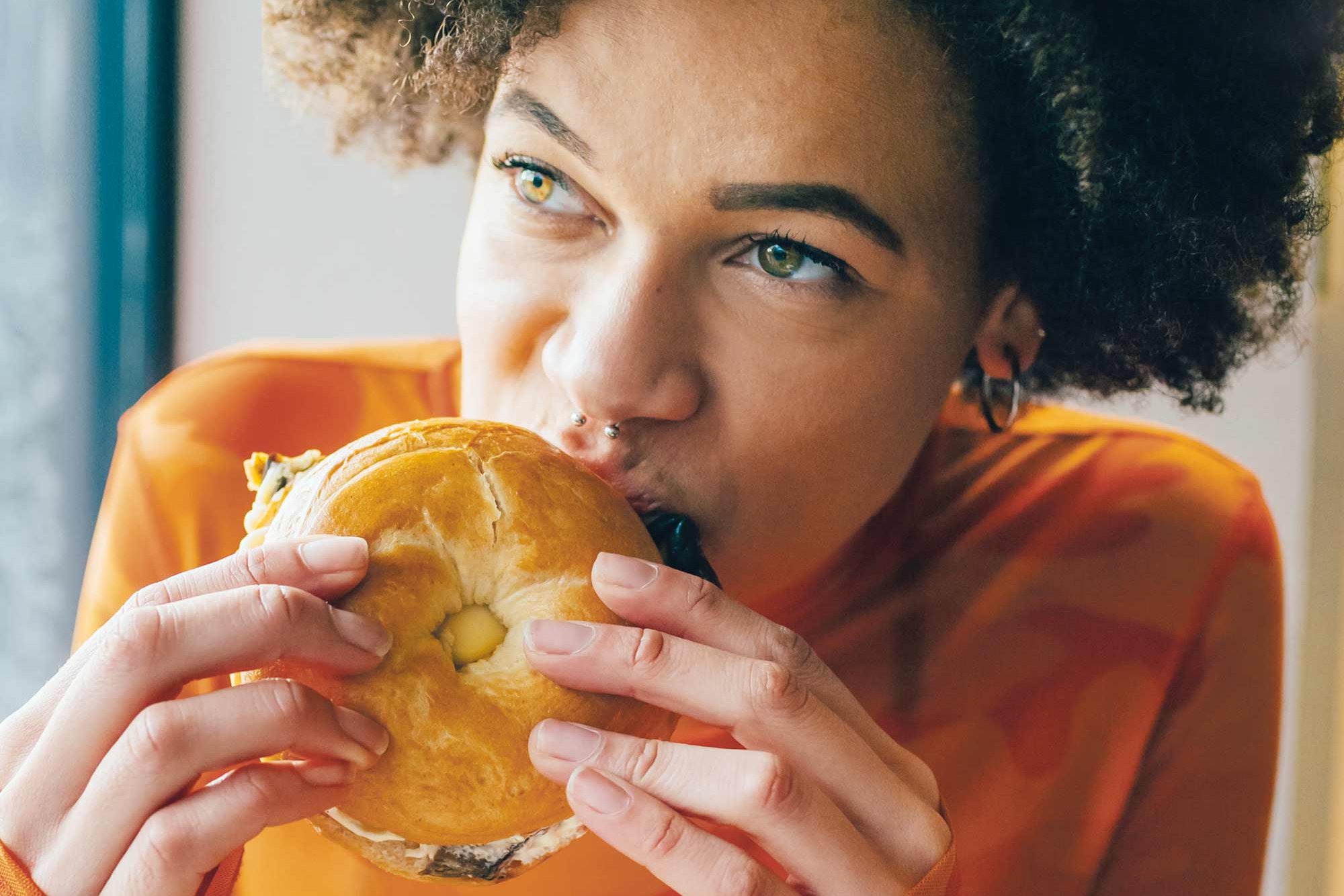Woman eating a bagel