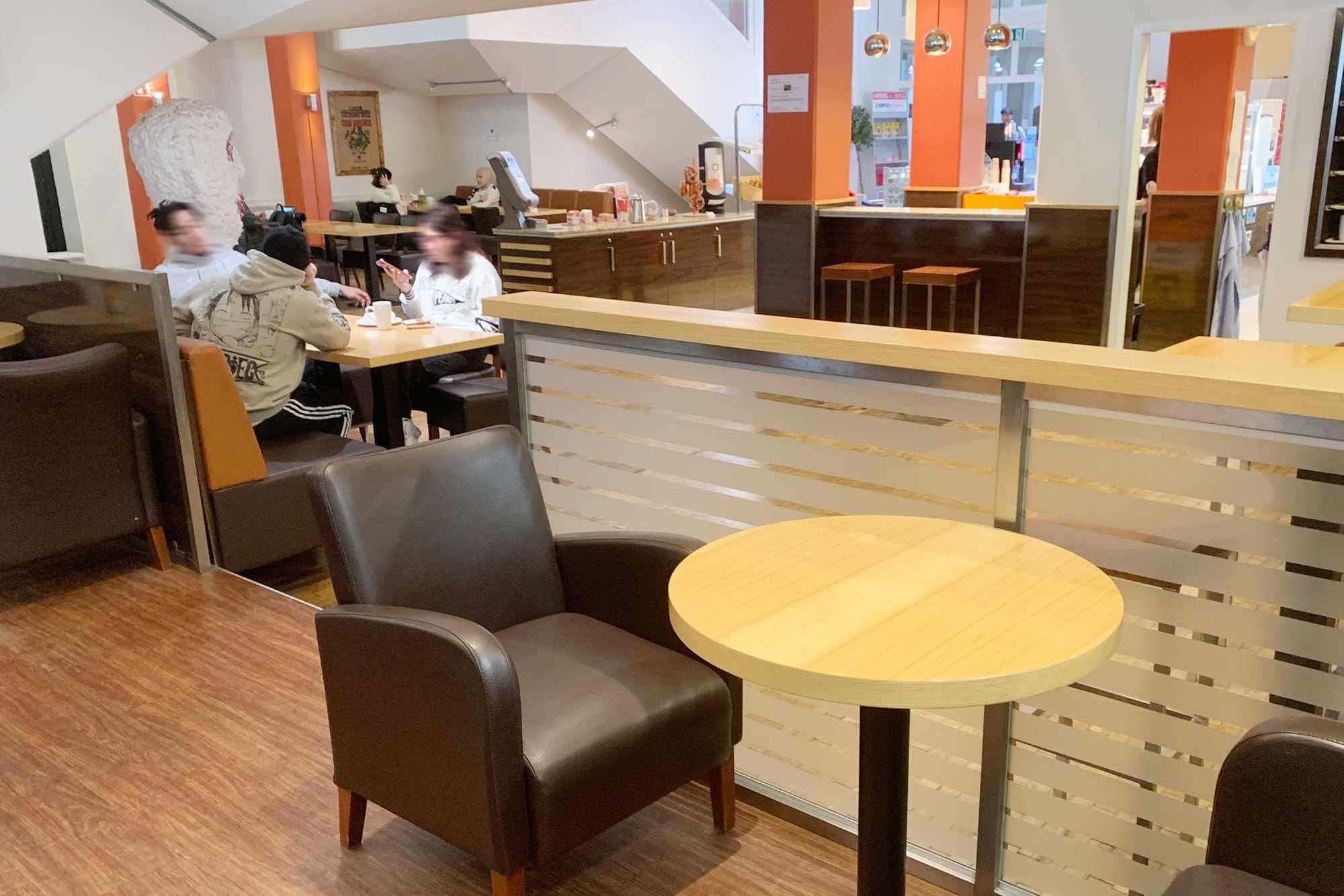 Seating area with guests in the Student Affairs café